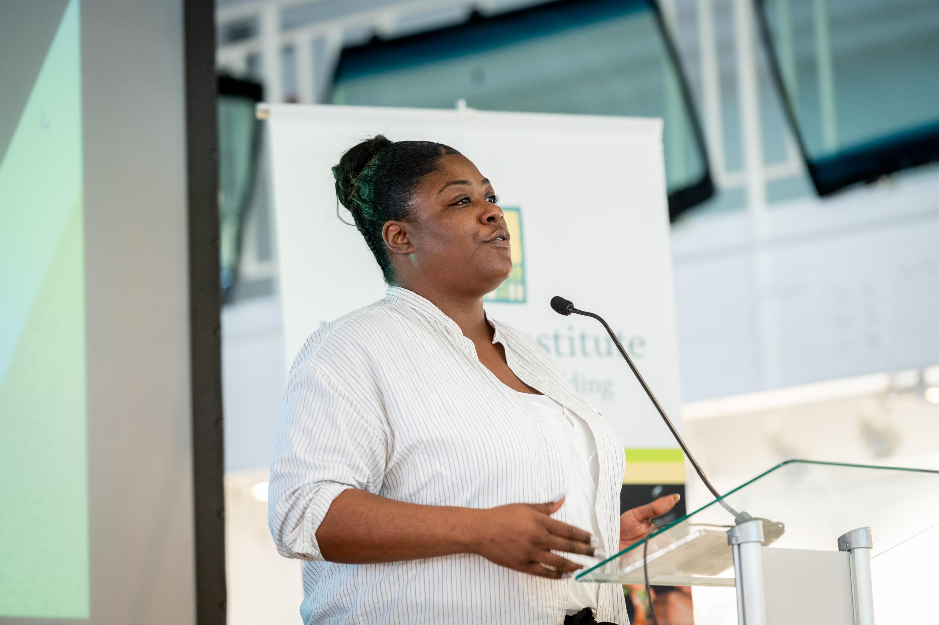 A person speaking at a podium.