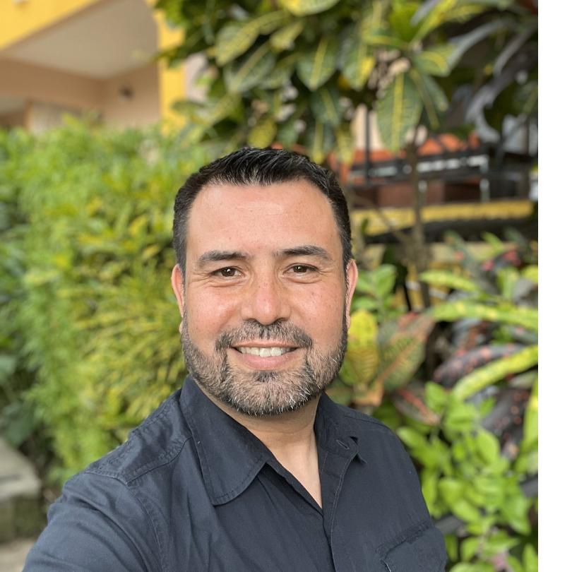 a man standing in front of plants